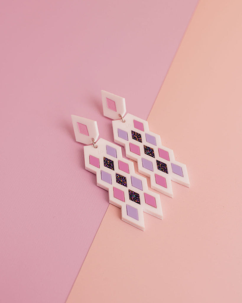 MISS MAIA, May 2022. The Taurikura in White sits on a pink and cream background