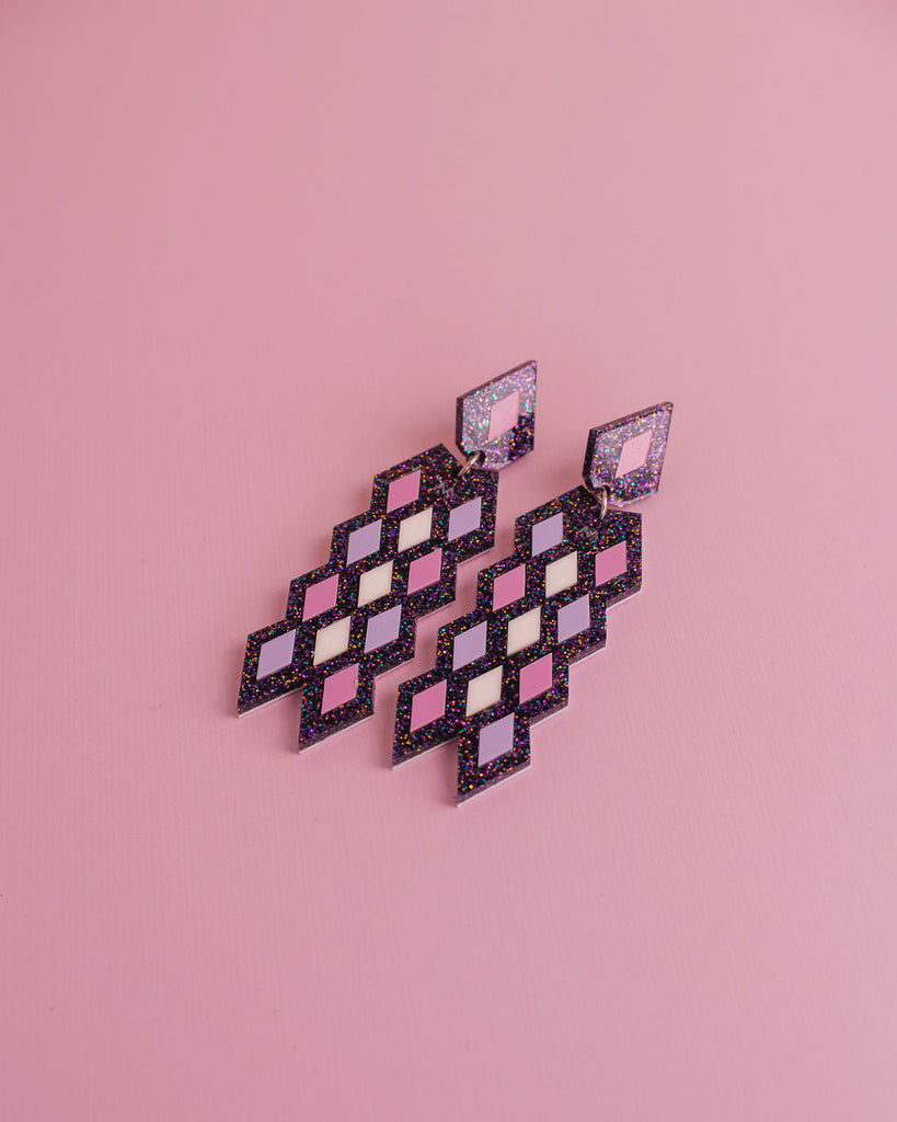 MISS MAIA, May 2022. The Taurikura in Galaxy purple sits on a pink background